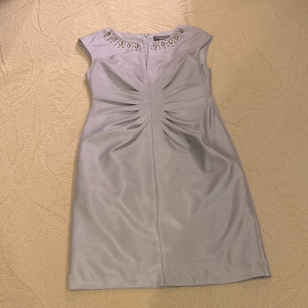 Silver dress with a design of Pearls and stones around the collar